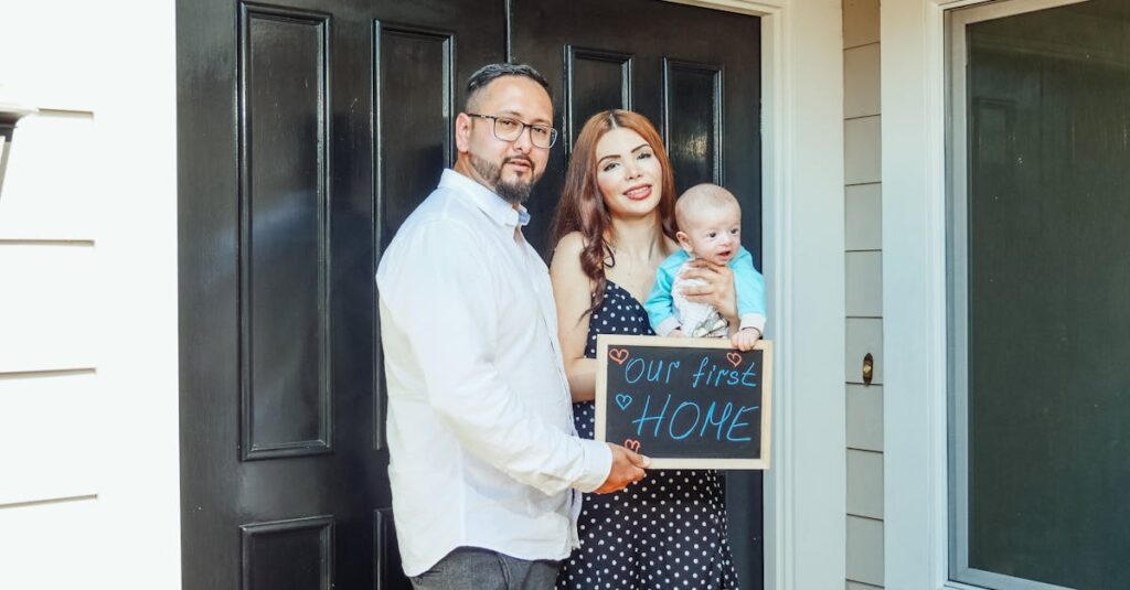Young family with baby holding a sign 'Our First Home' at doorstep, symbolizing new beginnings.